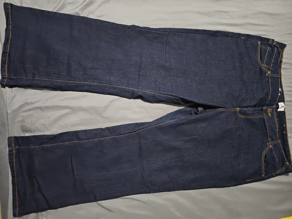 Dark wash denim jeans with contrast stitching five pocket button fly
